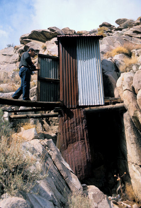 Stan Haye checks outhouse perched on side of cliff