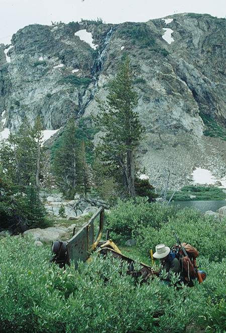 Cascade over Snow Lake and Gil Beilke examining old mine truck - Emigrant Wilderness - Aug 1993