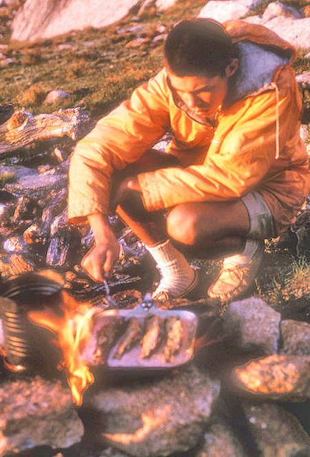 Mike Warren cooking fish in alpine glow at Burro Pass camp - Yosemite National Park - 22 Aug 1962