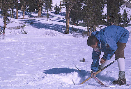 Steve Henderson digging hole in Gilbert Lake ice for water - Kearsarge Pass 1967