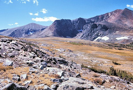This is the view southeast across Parker Pass. The rounded gray peak on the left is Parker Peak. The depression in front of the black mountain is occupied by Parker Pass Lake