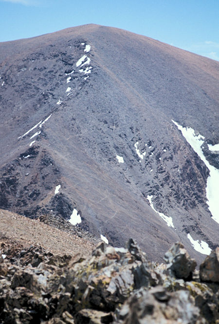 Looking at Parker Peak from Mt. Lewis. the trail from Parker Pass switchbacks up the ridge in the lower left of the picture and then cuts across the face of the mountain above the snow fields to Koip Peak Pass