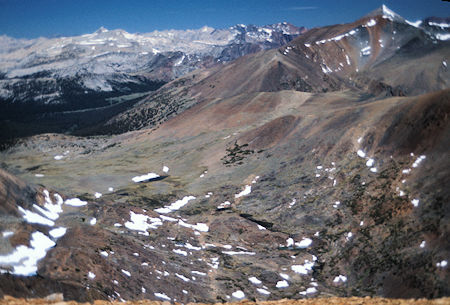From Parker Peak you have this fine view northwest of the Dana Fork. The meadow in the far trees is Dana Meadows just inside Yosemite National Park near Tioga Pass. Below in the lower center is the string of small lakes going up and to the left to Parker Pass. The slopes to the right of these lakes lead to Mt. Lewis. On the right skyline the pointed peak is Mt. Dana and just in front of it is Mt. Gibbs