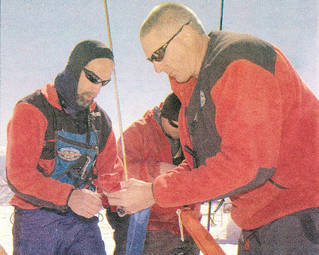 Search and Rescue volunteers Steve Case (left), John Hronesh (center) and Barry Beck (right) prepare their gear to join in the search - Susan Morning Photo